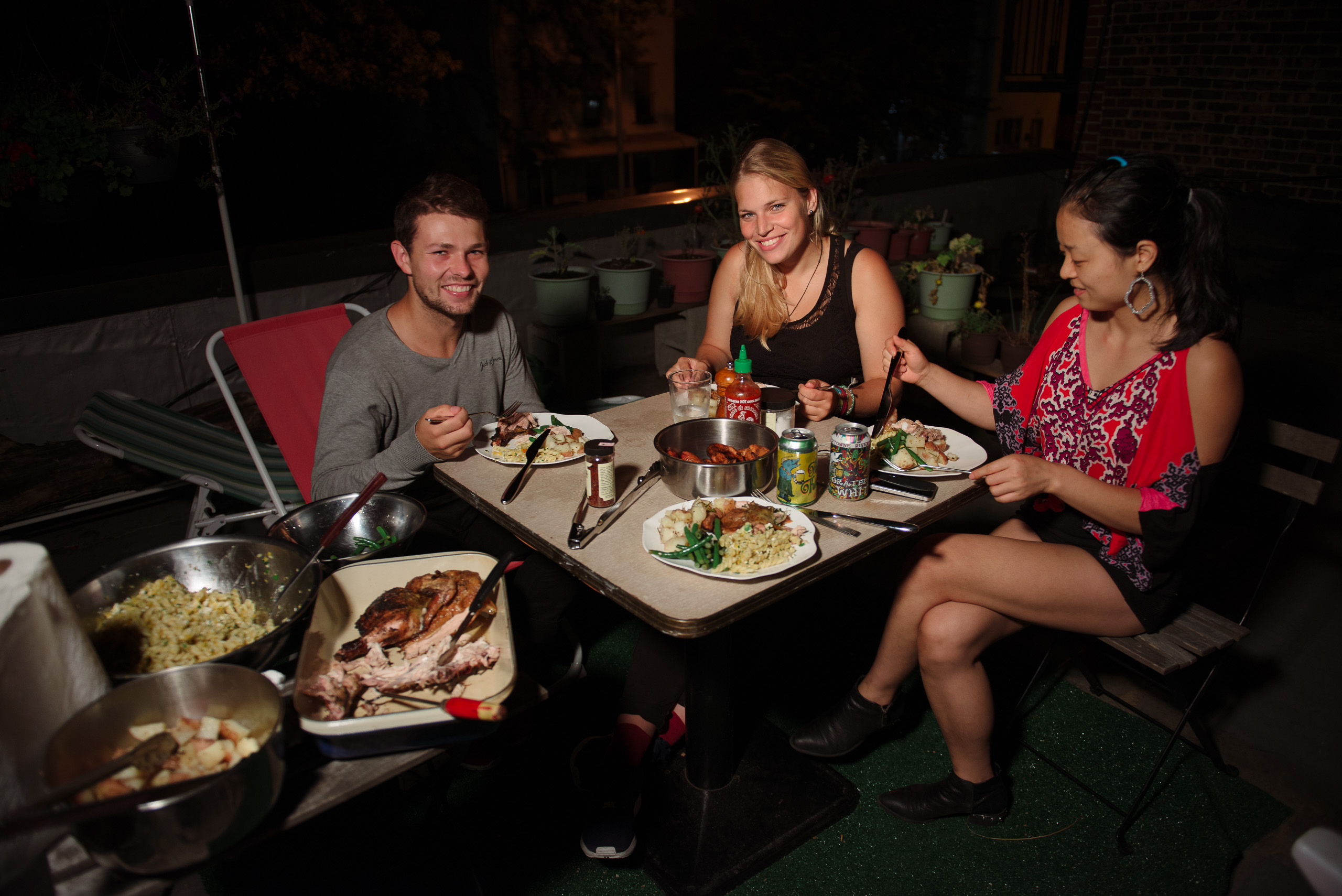 couchsurfers on roof having dinner
