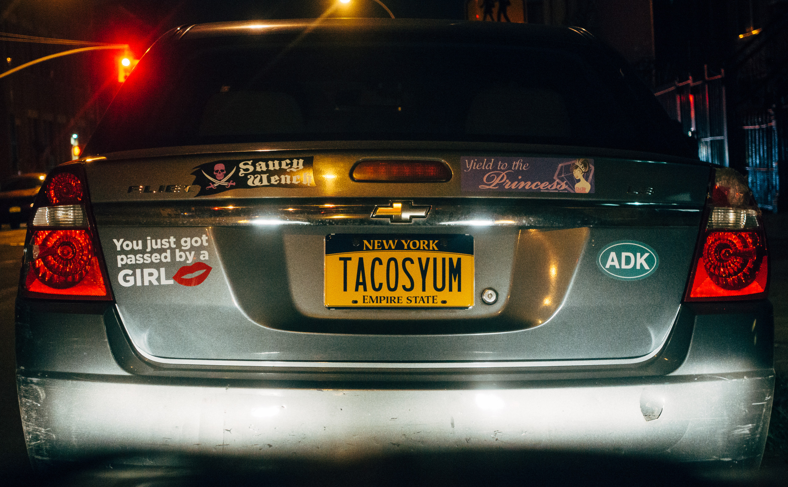 TACOSYUM on a license plate.