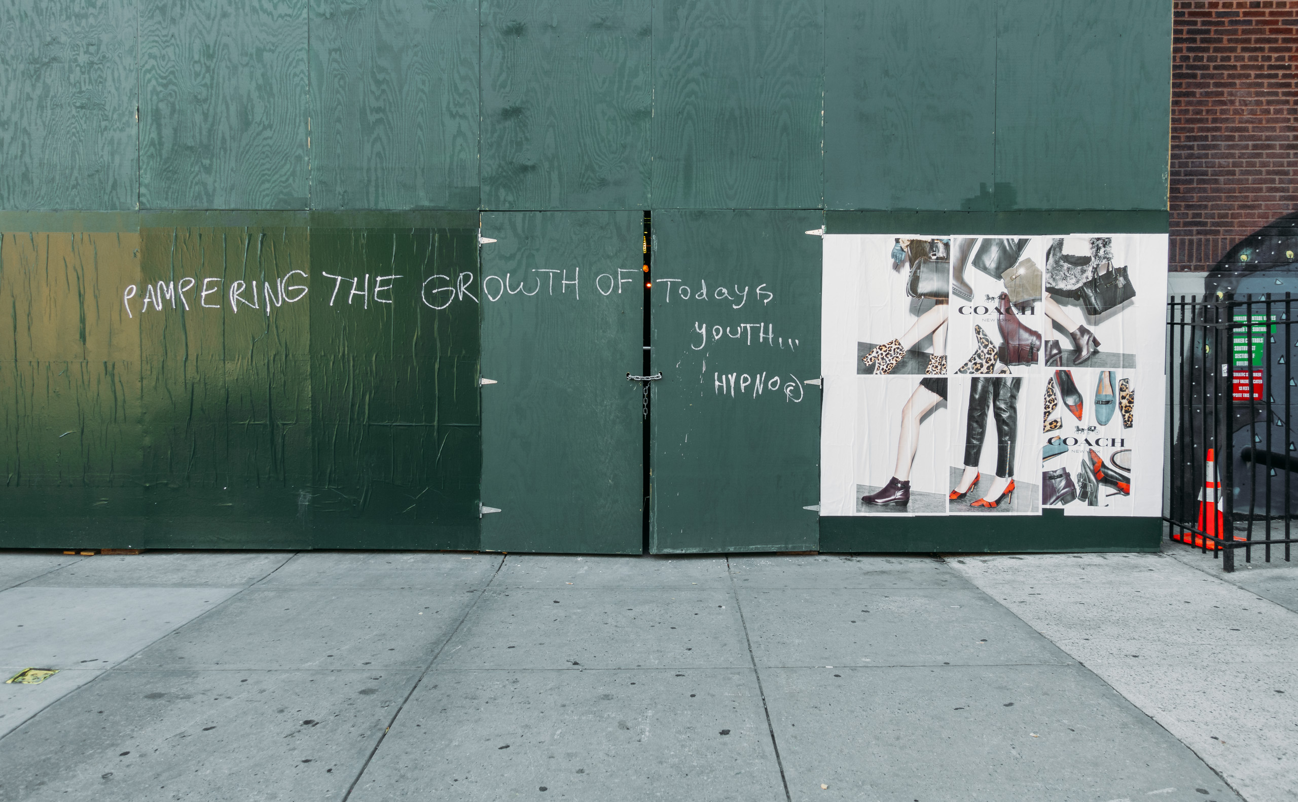 Signage and scrawl on a work site wall