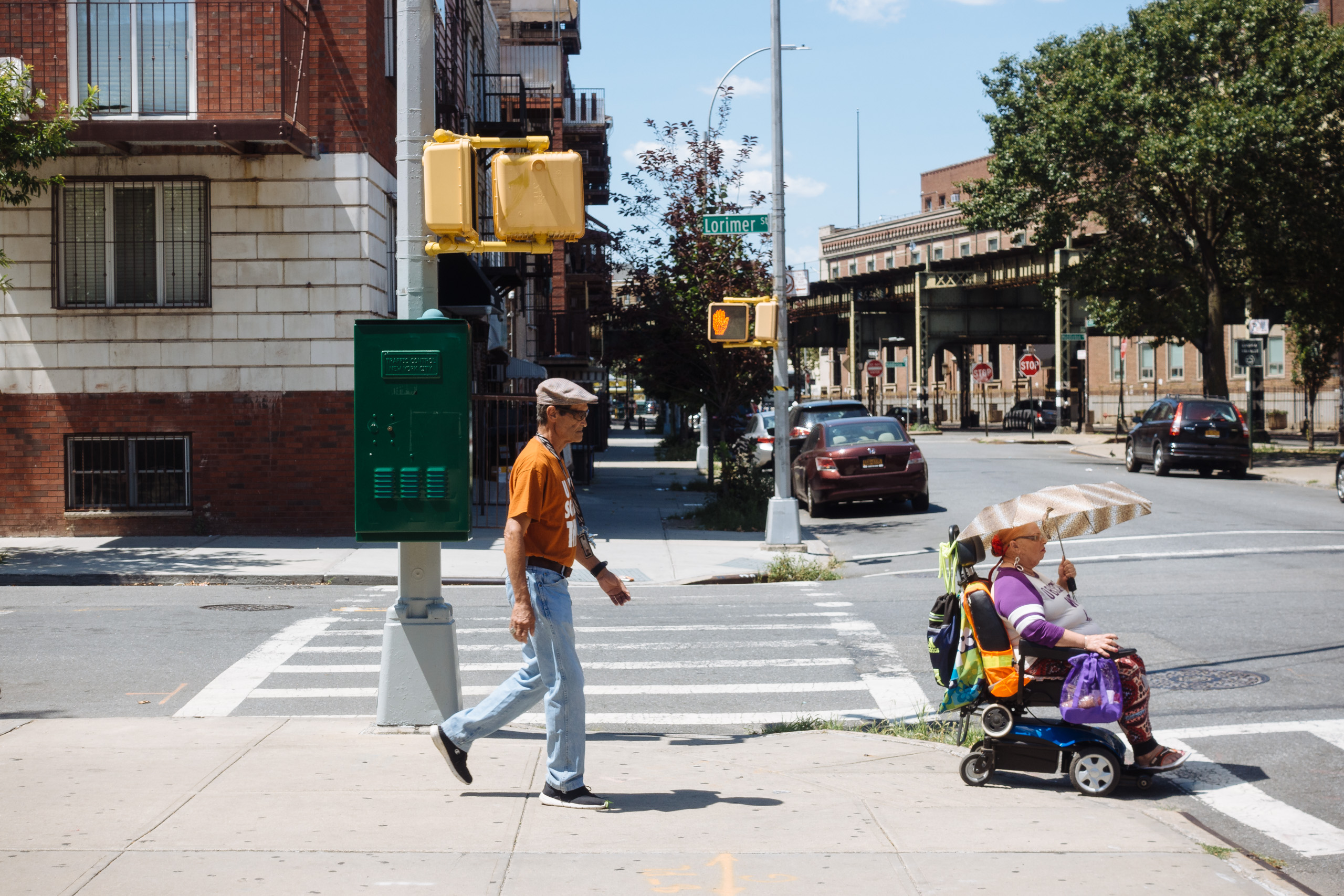 Woman in electric wheelchair with shade umbrella