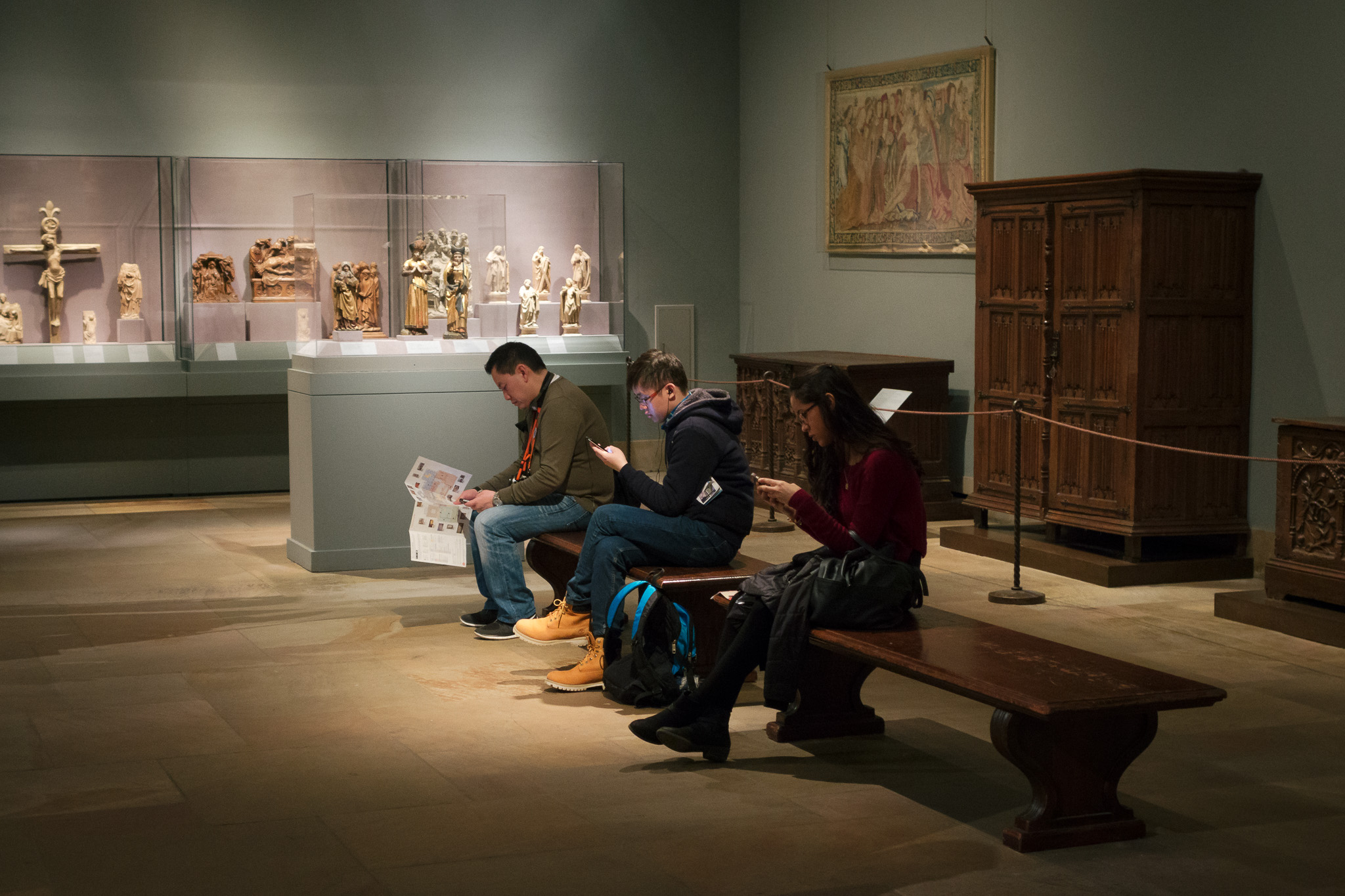 Museum patrons staring at smartphones