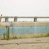 A ladder against a barrier along Beach Channel Drive