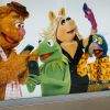 An advertiesment promoting the Muppet Show features recognizable Muppets operating smartphones