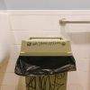 A trash bin in a men's room