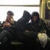 Commuters sharing secrets Commuters sharing secrets on J Train in Brooklyn Bed-Stuy