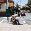 Woman in electric wheelchair with shade umbrella