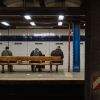 Men on a bench waiting for the train at Canal Street