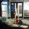 Man on curb, drunk, and leering.