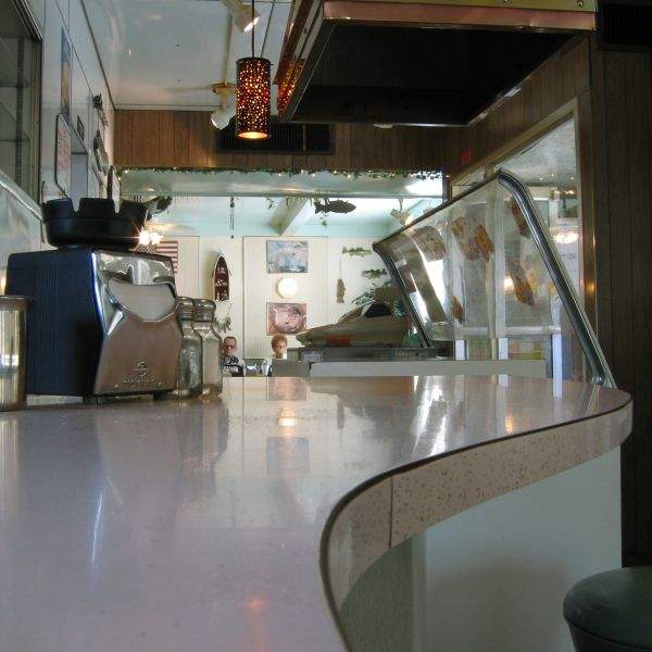 Streamlined countertop, curious old couple eating Sunday brunch.