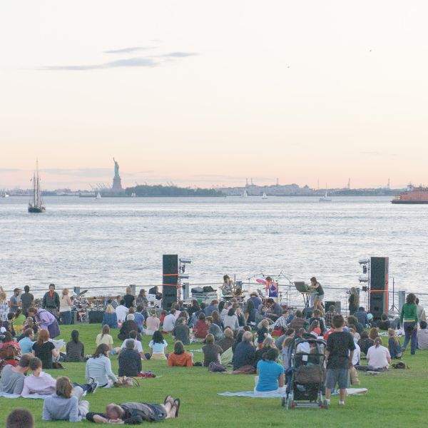 brooklyn bridge park walt whitman festival july grass statue of liberty