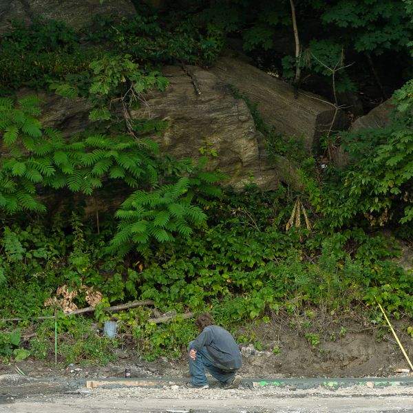 man writing in wet concrete