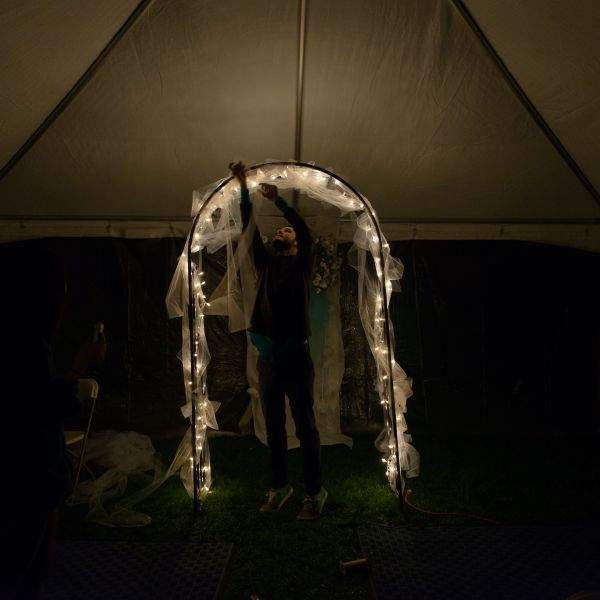 man decorating wedding archway
