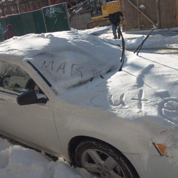 A message in the snow on a car