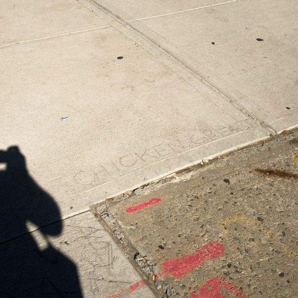 CHICKEN GREASE graffiti in sidewalk
