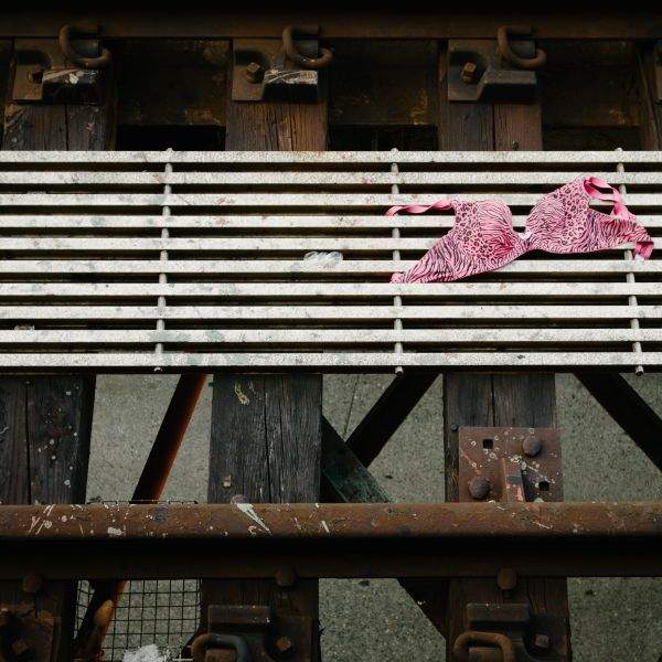 A pink leopard print bra or bikini top on train tracks