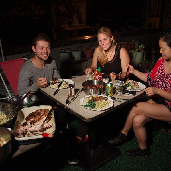 couchsurfers on roof having dinner