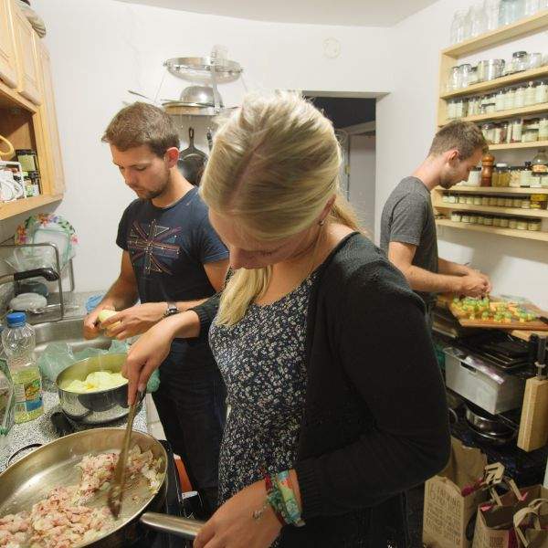 Surfers cooking in the kitchen