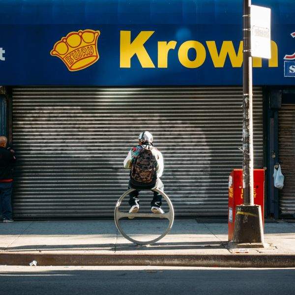 Man atop a ring, under a Krown.