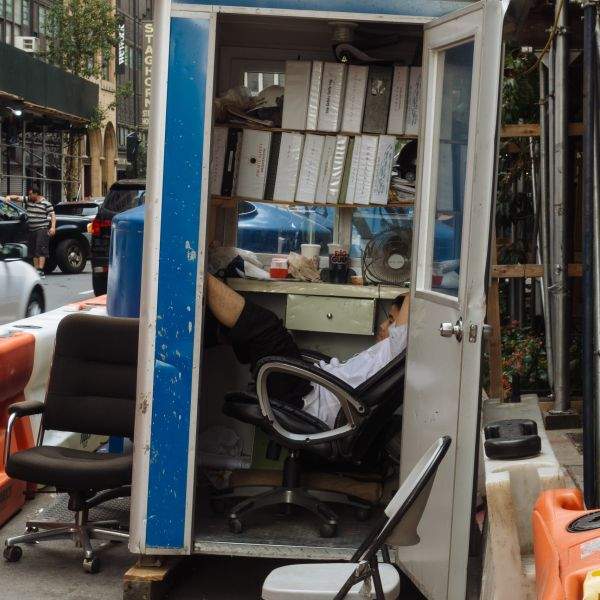 Young man kicking back in construction site office