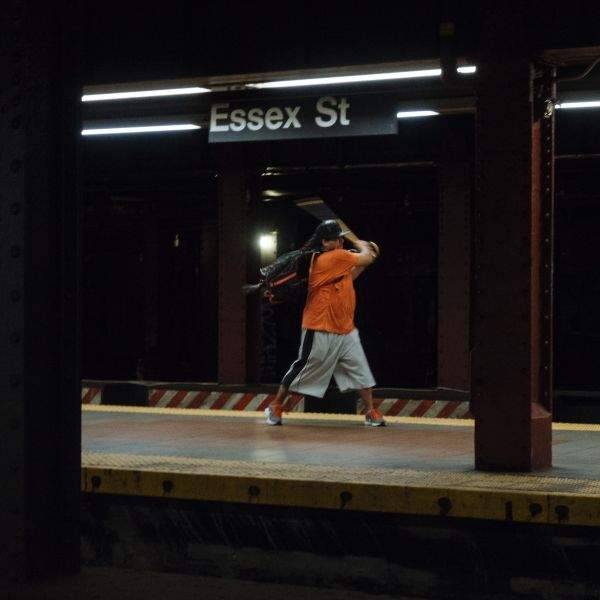 Man practicing batting swing with walking cane.