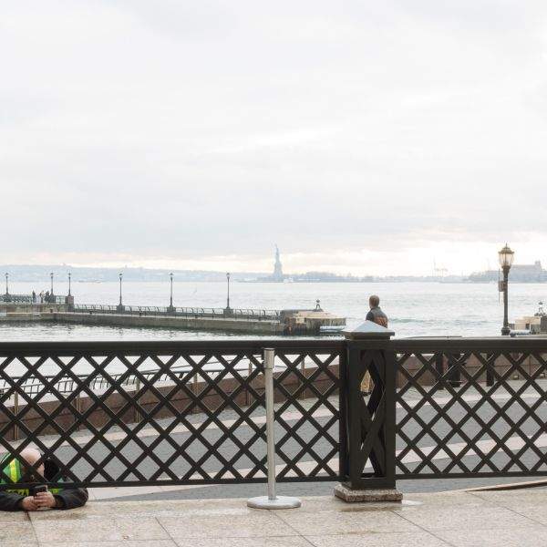 Security guard texts in the Battery Park Esplenade