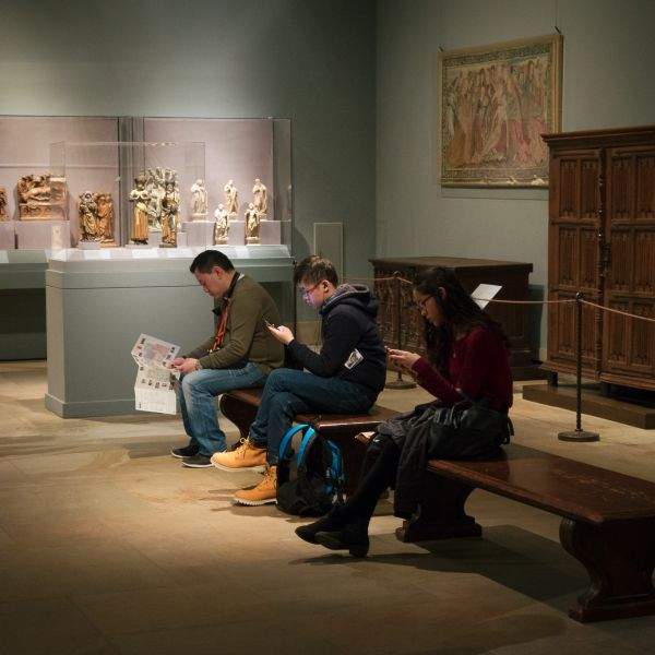 Museum patrons staring at smartphones
