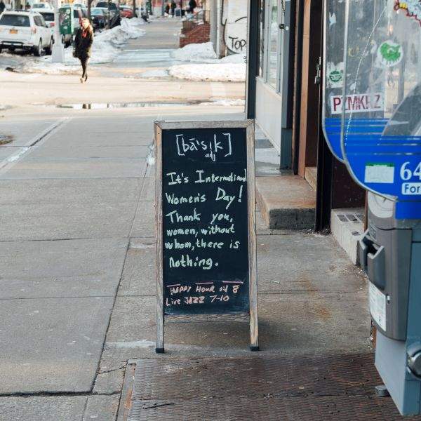 Woman's Day sign in front of Basik bar in East Williamsburg