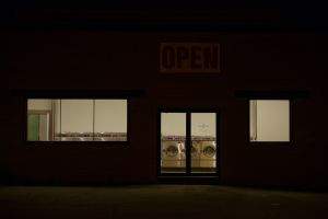 Laundromat storefront at night
