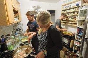 Surfers cooking in the kitchen