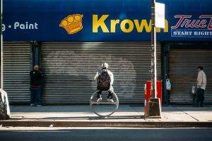 Man atop a ring, under a Krown.
