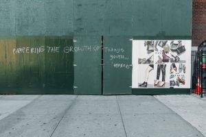 Signage and scrawl on a work site wall