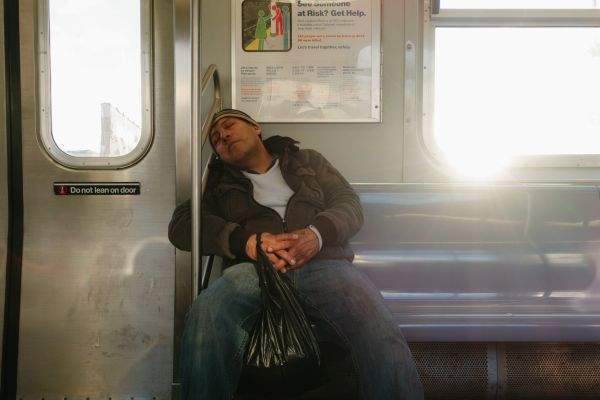Subway sleeper on a Manhattan bound J train