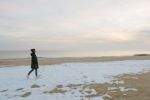 Alessandra on the beach woman walking snow-covered coney island beach