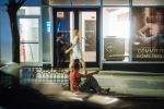 Man on curb, drunk, and leering. Man on curb, drunk, and leering.
