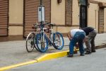 men painting curb in bed-stuy