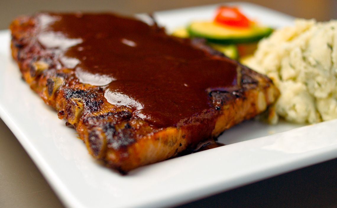 double wide grille pittsburgh pa ribs covered in BBQ sauce