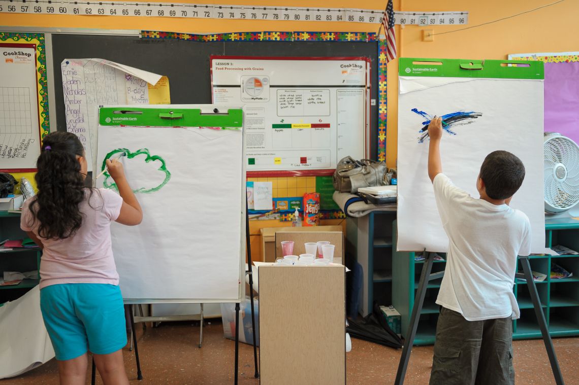 kids painting in front of classroom