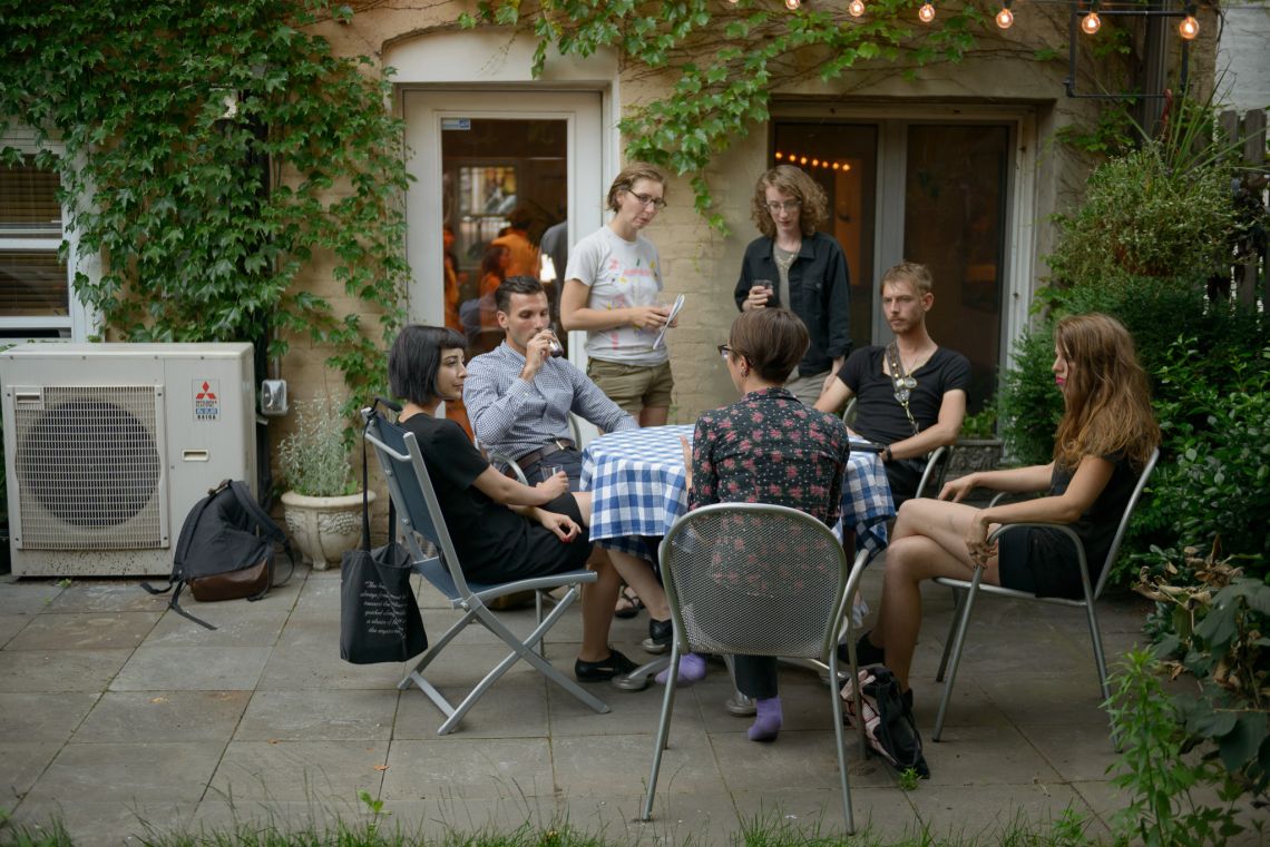 Guests mingle and chat outside.