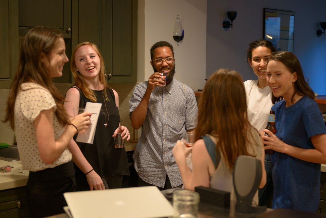 Guests gather in the kitchen.