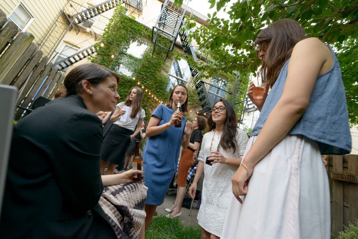 Guests mingle and chat outside.