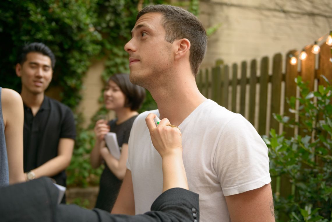 A guest is spritzed with a pheromone for men.