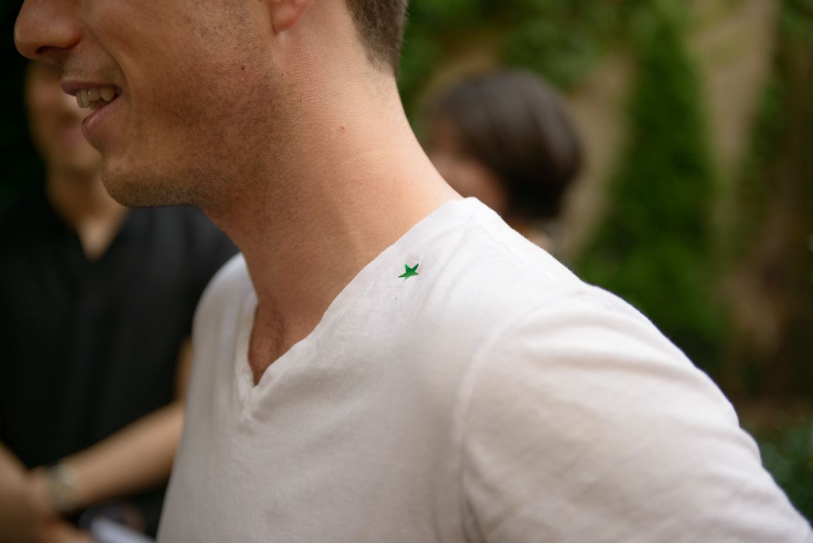 The guest tagged with a green star, signifying pheromone he was sprayed with.
