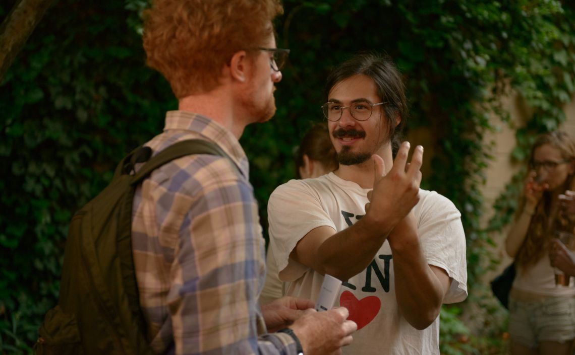 Artist in residence Daniel Fishkin speaks with a guest.