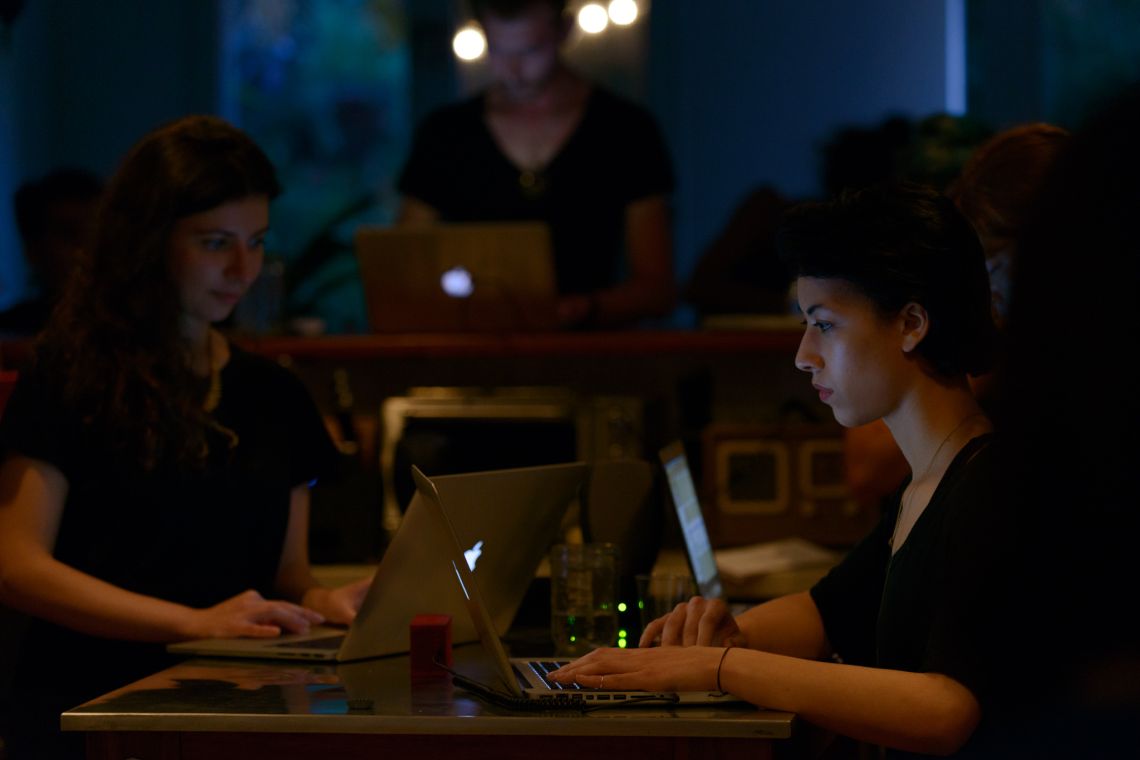 Performers at their laptops in Body Piece (2014)