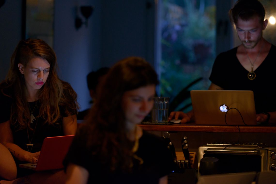 Performers at their laptops in Body Piece (2014)