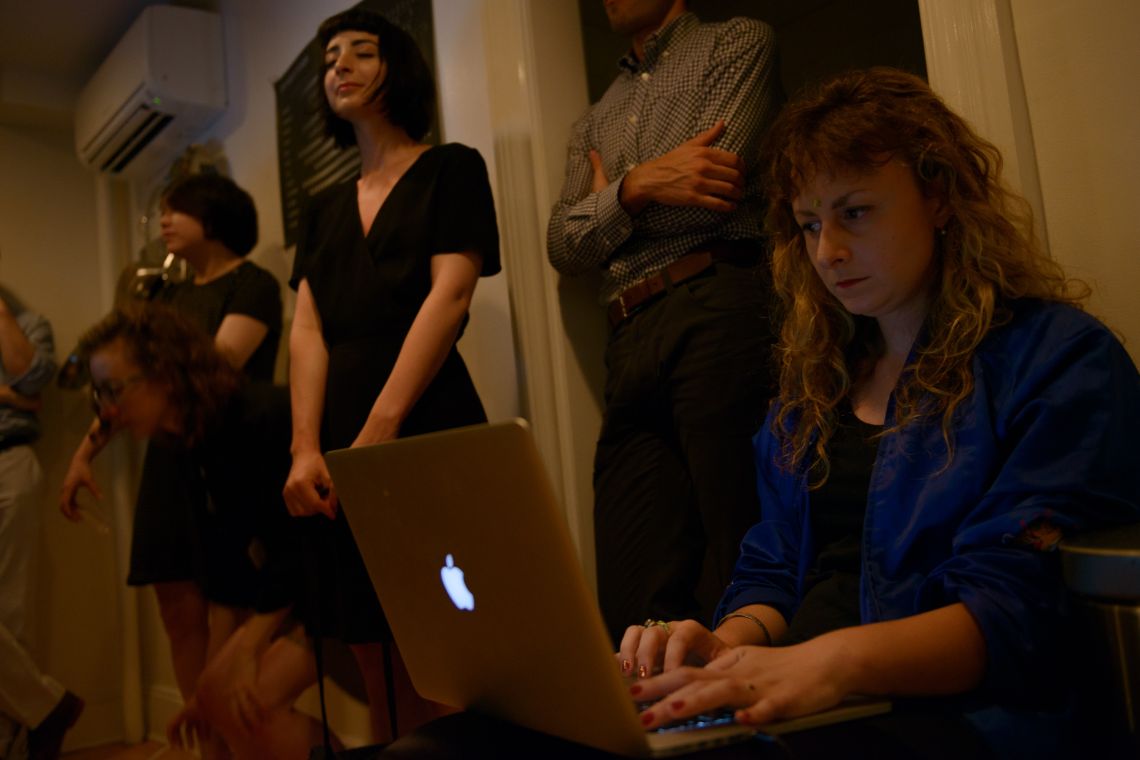 Performer at her laptops in Body Piece (2014)