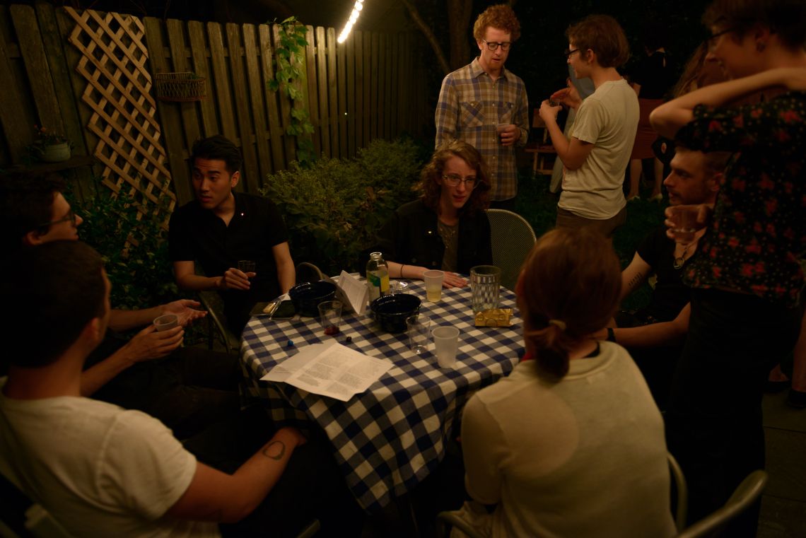 Evening sets in and guests continue to chat and mingle.