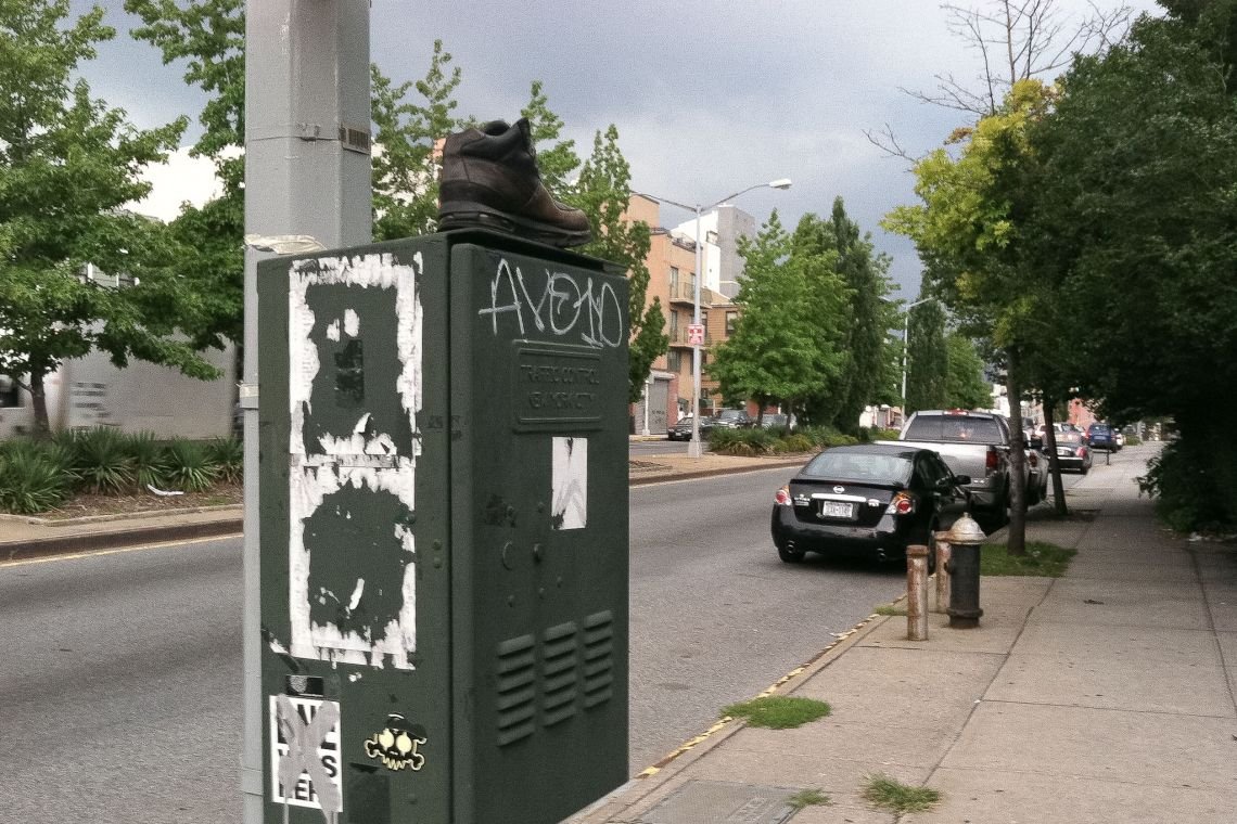 boot on traffic utility box at intersection