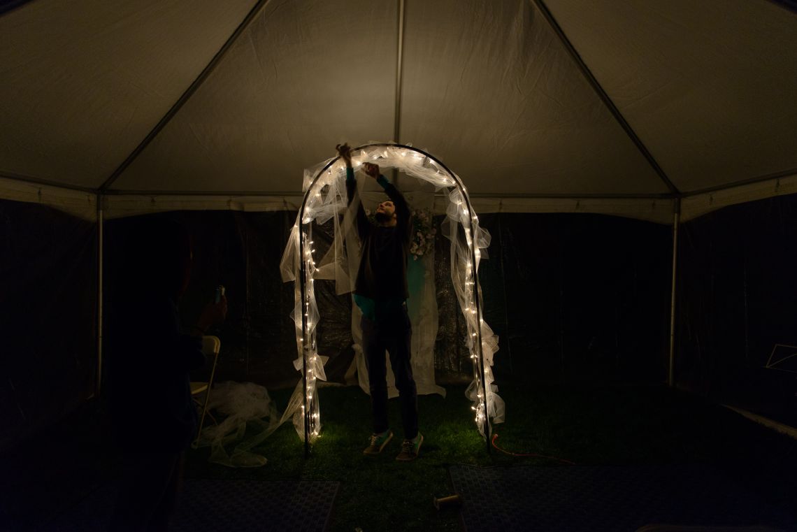 man decorating wedding archway