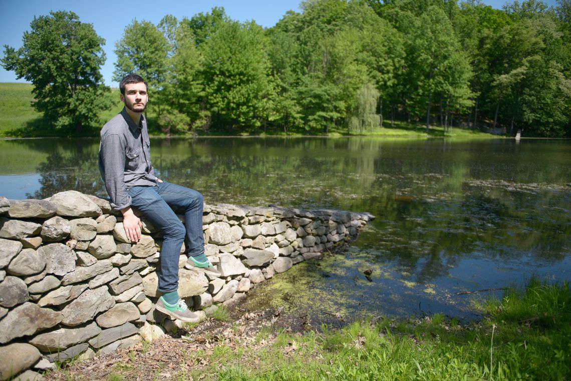 sitting on stone art wall